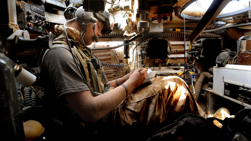 Prince Harry sitting below the turret of his Spartan armored vehicle as he communicates with other units by radio, in the desert in Helmand province in Southern Afghanistan, on February 20, 2008. The 23-year-old, an officer in the Household Cavalry regiment, secretly served for several weeks in the volatile southern province of Helmand.