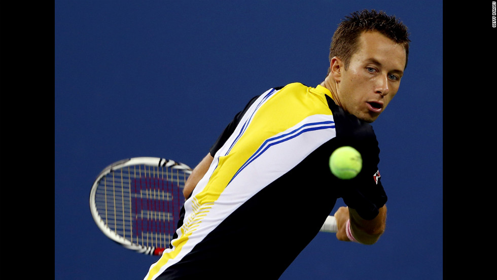 Philipp Kohlschreiber of Germany returns a shot to John Isner of the United States on Sunday.