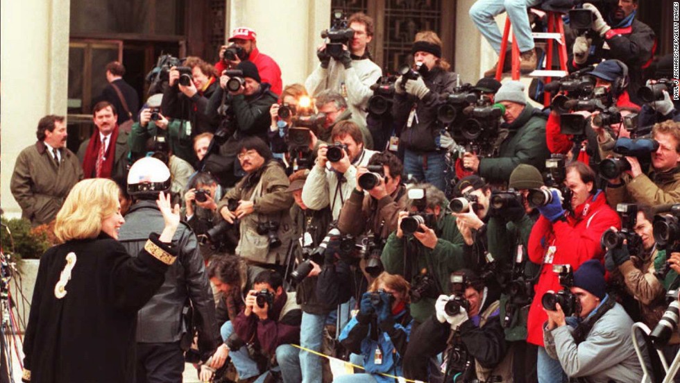 Clinton waves to the media on January 26, 1996, as she arrives at federal court in Washington for an appearance before a grand jury. The first lady was subpoenaed to testify as a witness in the investigation of the Whitewater land deal in Arkansas.