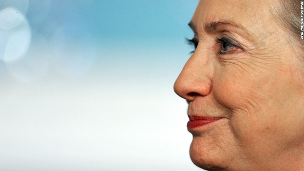 Clinton listens as Turkish Foreign Minister Ahmet Davutoglu makes a brief statement November 29, 2010, before a bilateral meeting at the State Department in Washington.