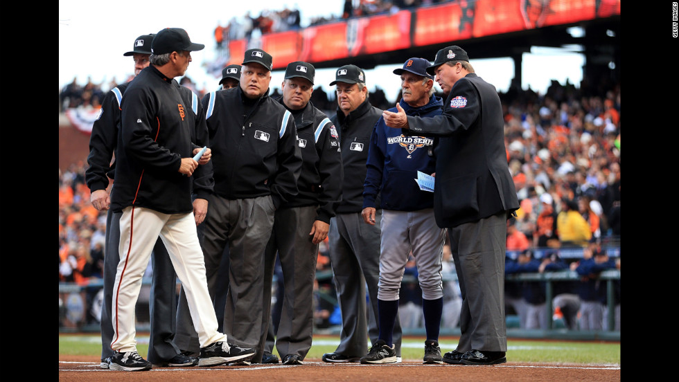 Manager Bruce Bochy, left, of the San Francisco Giants, and manager Jim Leyland, right, of the Detroit Tigers, go over ground rules with the umpires prior to the game.
