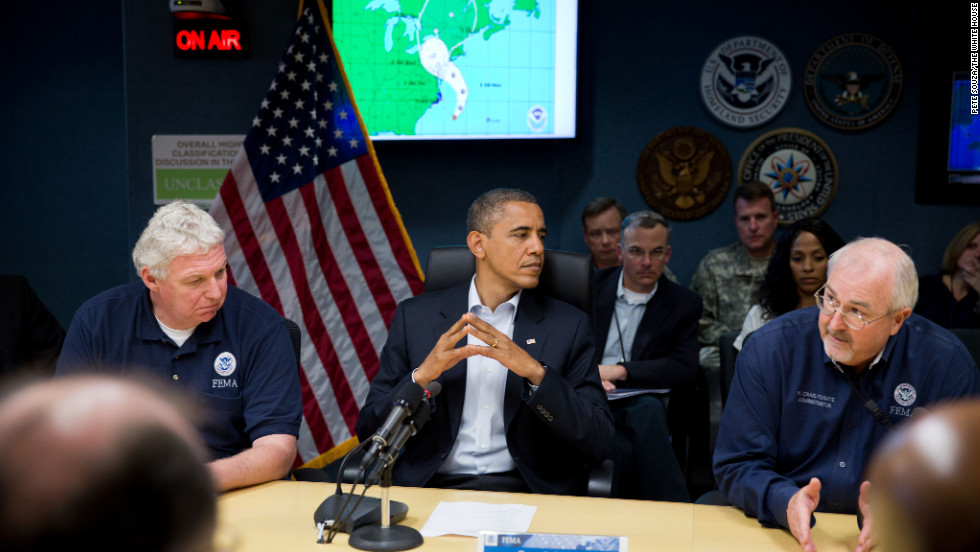 Obama, seated between FEMA Administrator Craig Fugate (r) and Richard Serino, FEMA deputy administrator, (l) receives an update on the response to Hurricane Sandy at the National Response Coordination Center at FEMA headquarters in Washington on Oct. 28, 2012.