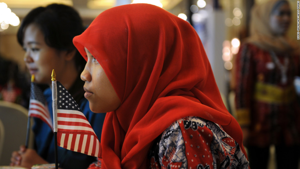 Indonesian student Anisa Widya Lestari, 20, holds a U.S. flag while watching election returns at a poll monitoring center set up by the U.S. Embassy in Jakarta on Wednesday, November 7. President Barack Obama spent some of his early childhood in the Indonesian capital.