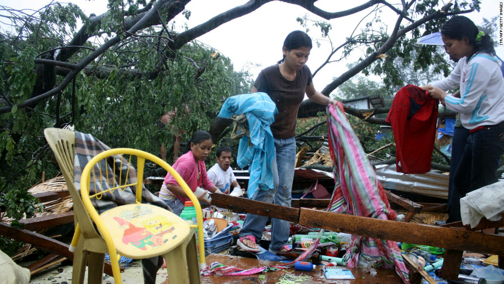 Residents gather their belongings after their house was destroyed by strong winds brought about by the storm in Cagayan de Oro City, on the southern island of Mindanao, on Tuesday, December 4.  
