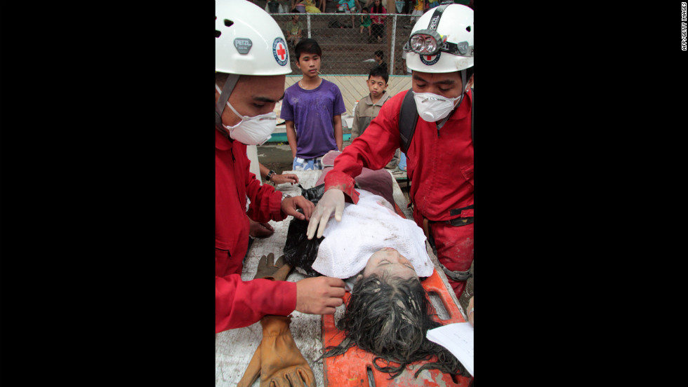 Red Cross volunteers assist a rescued child in New Bataan on December 5.