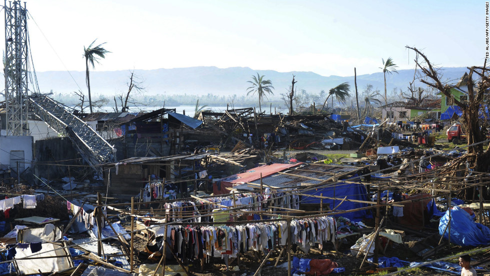 Clothes hang next to destroyed houses and toppled trees in the town of Cateel, Davao Oriental province, on December 11.