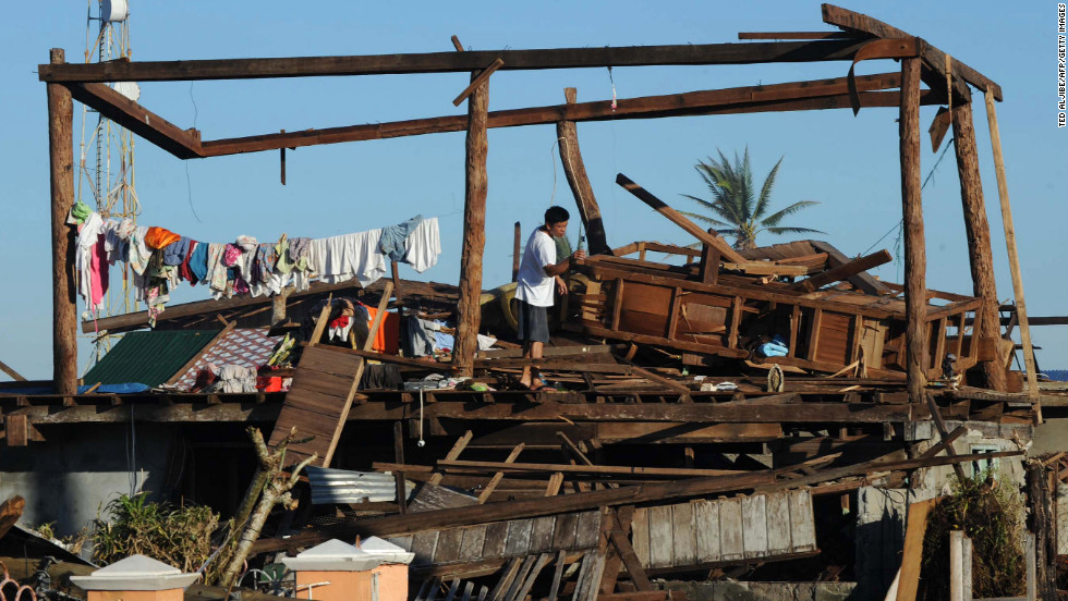 A resident stands on his destroyed house in Cateel on December 11.