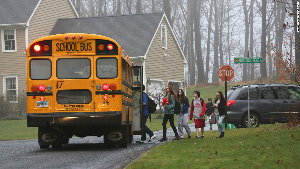 Children in Newtown, Connecticut, return to school on December 18, 2012, four days after the shooting at Sandy Hook Elementary School.