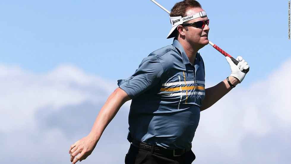 Charlie Beljan leans into the wind after taking a rehit on a tee shot on Sunday, when play was called off for the third day in a row in the PGA Tour's season-opening event.