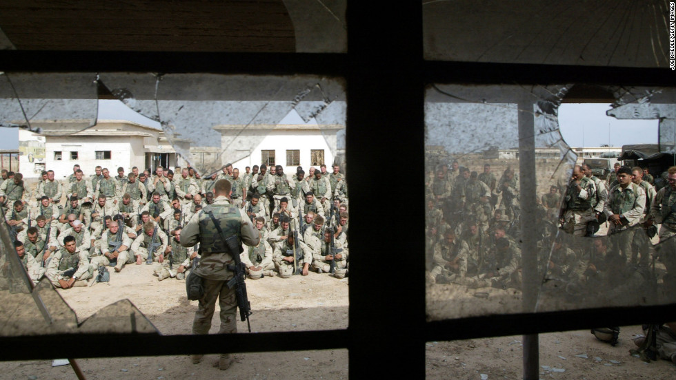 Marines hold a memorial service for friends killed in a battle weeks earlier on April 13, 2003, near Al-Kut, Iraq.