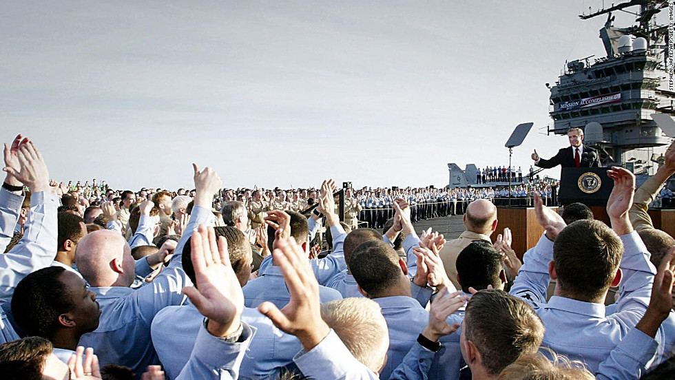 Sailors applaud as President Bush addresses the nation aboard the USS Abraham Lincoln on May 1, 2003. Standing beneath a banner that read &quot;Mission Accomplished,&quot; the president declared major fighting over in Iraq and called it a victory in the ongoing war on terrorism.