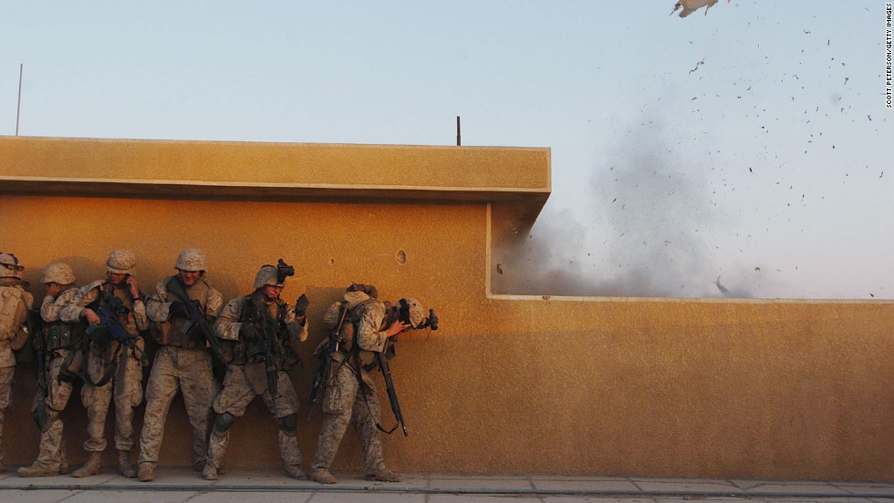 Marines use explosives to open rooftop doors while searching houses in Fallujah for insurgents on November 22, 2004.