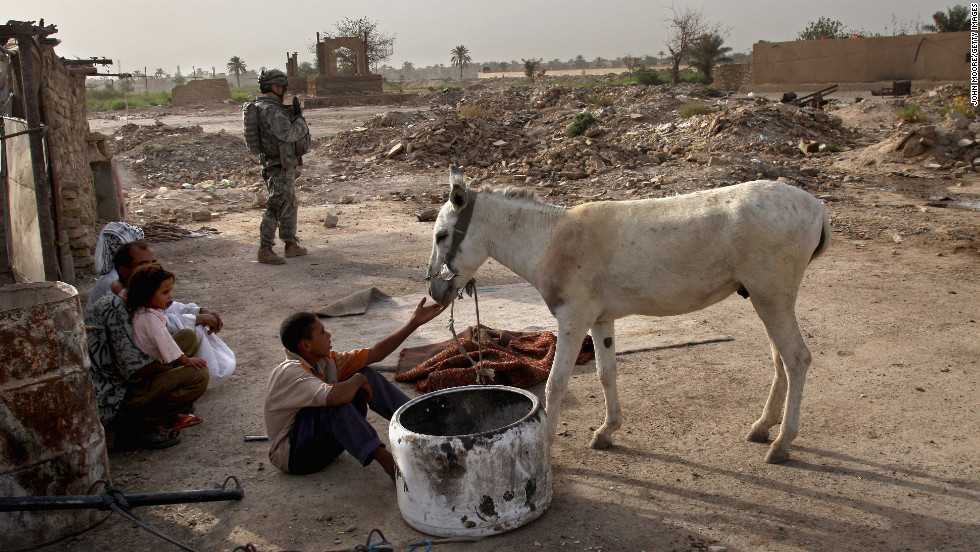 An American soldier prepares to search a home for illegal weapons in the Hurriyah neighborhood of Baghdad on September 9, 2007.