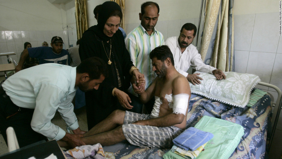 Relatives help an Iraqi man at a hospital in Baghdad on September 20, 2007. He was injured when Blackwater security contractors opened fire on civilians on September 16, killing 17. The company lost its contract to guard U.S. staff in Iraq after the country's government refused to renew its operating license.