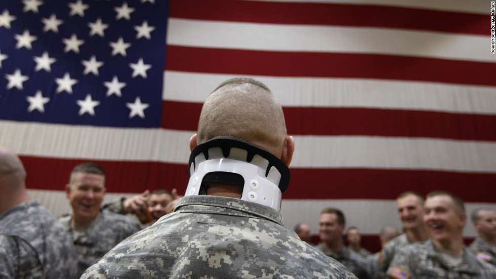 Pfc. Jeremy Tomlinson, who was wounded a year before in Iraq, waits with fellow soldiers to greet returning comrades in Fort Carson, Colorado, on January 28, 2008. About 3,800 soldiers were coming home after a 15-month tour of duty.