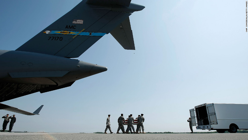 A U.S. Air Force team carries a flag-draped transfer case containing the remains of Army Spc. Omar M. Albrak of Chicago at Dover Air Force Base in Delaware on May 12, 2009, just over a month after the U.S. government lifted its ban on media coverage of the returning war dead. Albrak was killed while serving in Iraq.