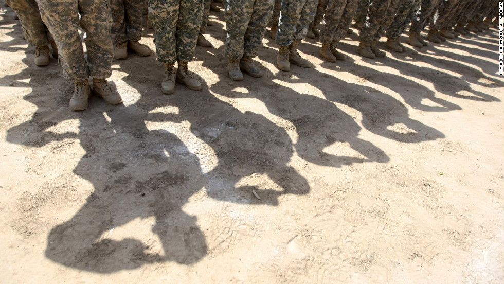 U.S. soldiers salute during a handover ceremony of the entry points of Baghdad's Green Zone, now referred to as the International Zone, to Iraqi control inside the heavily fortified compound in Baghdad on June 1, 2010.