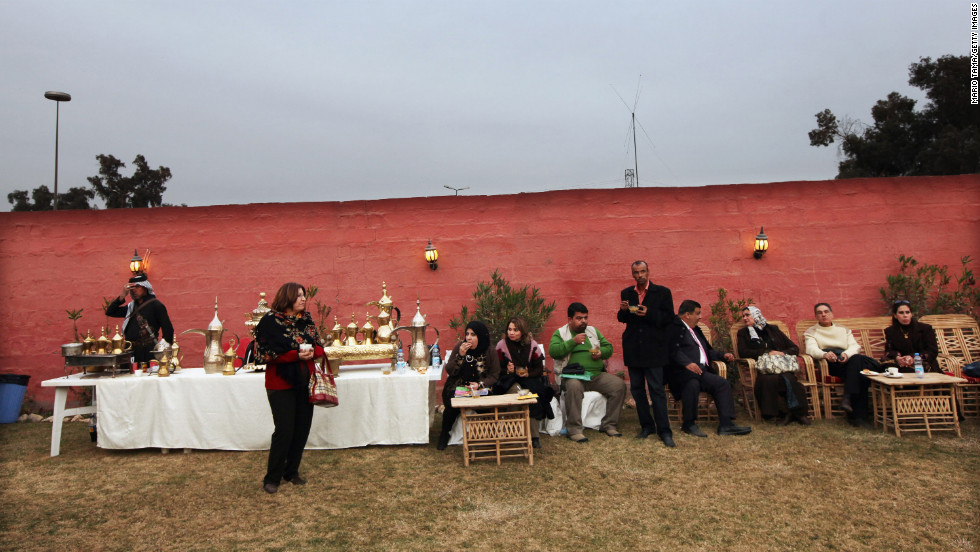 Iraqis gather at a women's art exhibition in a posh Baghdad neighborhood on December 14, 2011.