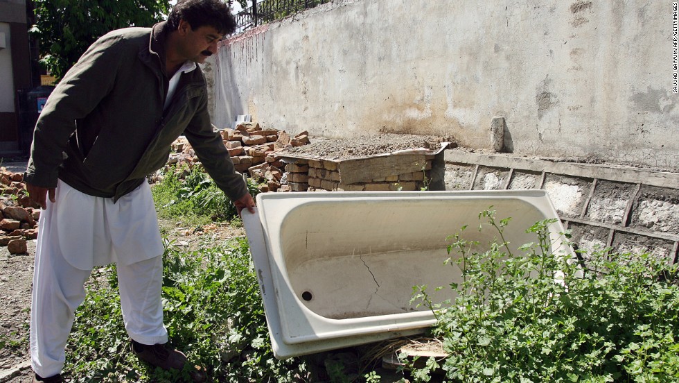 Contractor Yusufzai looks at a bathtub left over from the demolition on May 1, 2012.