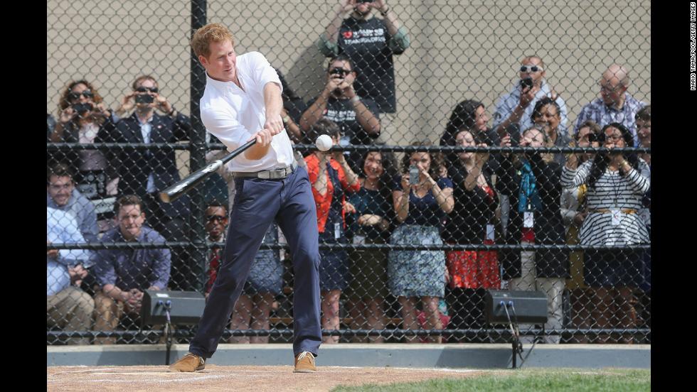 Prince Harry hits a baseball while participating in drills at the Harlem RBI baseball youth development program in New York City on Tuesday, May 14. 