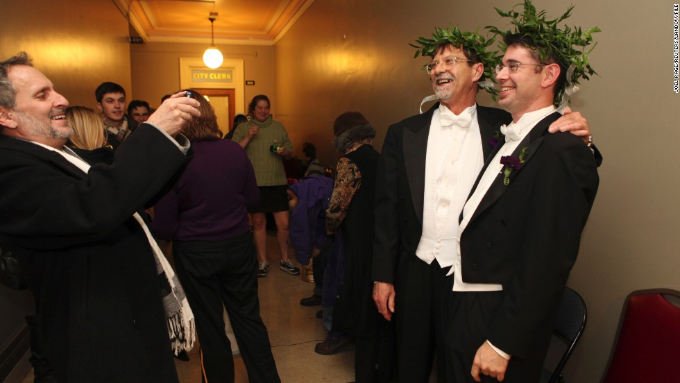 Jamous Lizotte, right, and Steven Jones pose for photos while waiting for a marriage license in Portland, Maine, in December 2012.