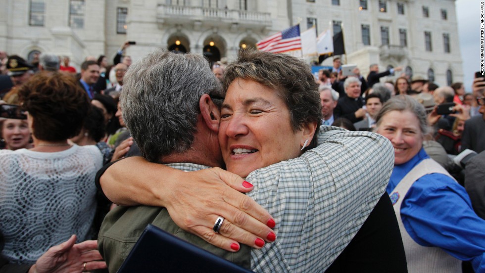 Rhode Island state Sen. Donna Nesselbush, right, embraces a supporter after the Marriage Equality Act was signed into law at the statehouse in Providence in May 2013.