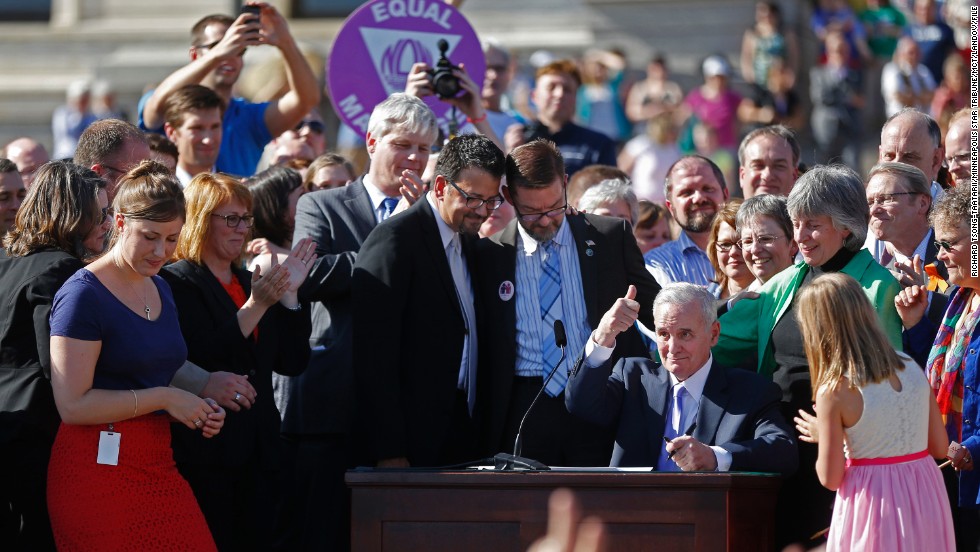 At the state Capitol in St. Paul, Minnesota, Gov. Mark Dayton signs a bill legalizing same-sex marriage in May 2013.