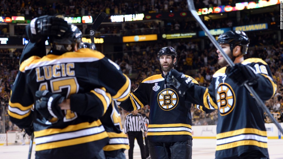 Milan Lucic of the Boston Bruins, left, celebrates with his teammates after scoring a goal in the third period.