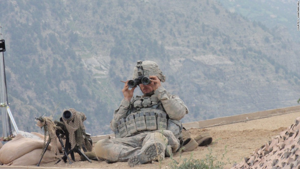 Carter on top of an Afghanistan Support Group (ASG) hut, providing eyes on an enemy attack and the approach/extraction route.