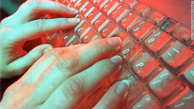 A photo illustration depicts a person typing May 4, 2001 in Denver, CO.