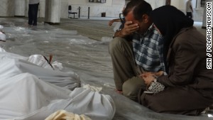 A Syrian man mourns over the bodies of those killed in an alleged chemical weapons attack in Damascus, Syria, in 2013.