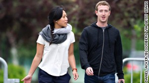 Mark Zuckerberg walks with his wife, Priscilla Chan.