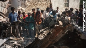 Somalis look at the wreckage of a U.S. helicopter in Mogadishu in October 1993.