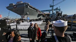 Ben Hansen, a U.S. Navy boatswain's mate, and his wife, Jessica, join in the festivities as the Navy's newest nuclear-powered aircraft carrier, the USS Gerald R. Ford, gets christened in November in Newport News, Virginia. The Gerald R. Ford is the first ship in the Navy's newest class of aircraft carriers under the same name.