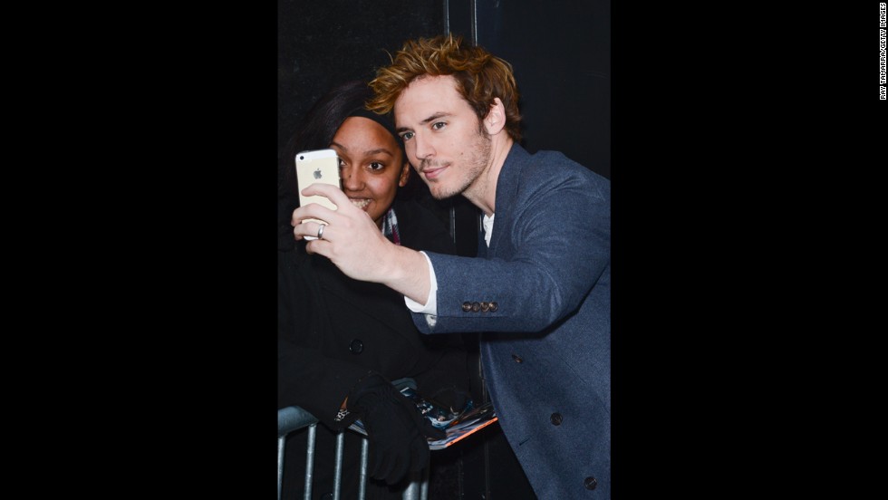 Actor Sam Claflin poses for photos with fans in New York City.