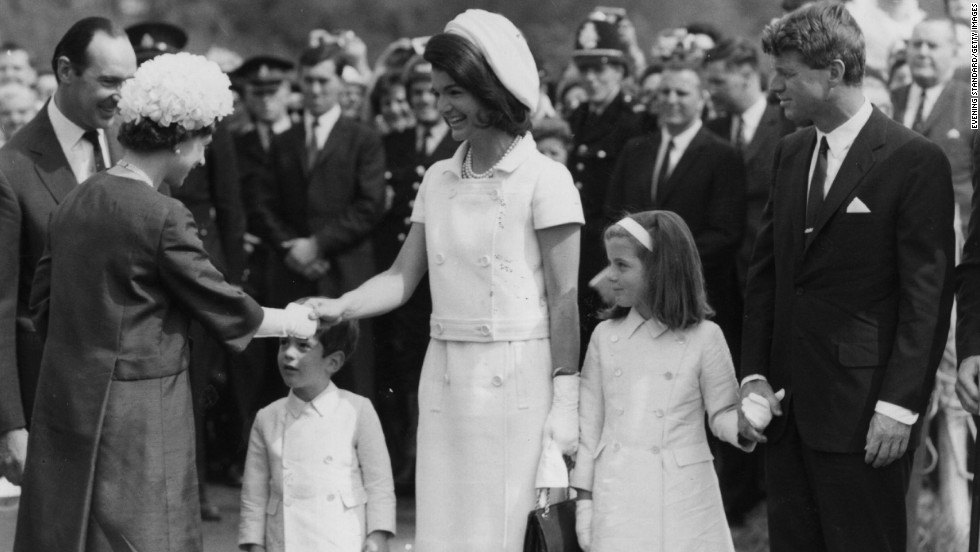 Caroline, alongside her mother and uncle Robert Kennedy, greet Queen Elizabeth II in London in 1965.