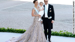 Crown Princess Victoria, Princess Estelle and Prince Daniel pose at a 2013 wedding.