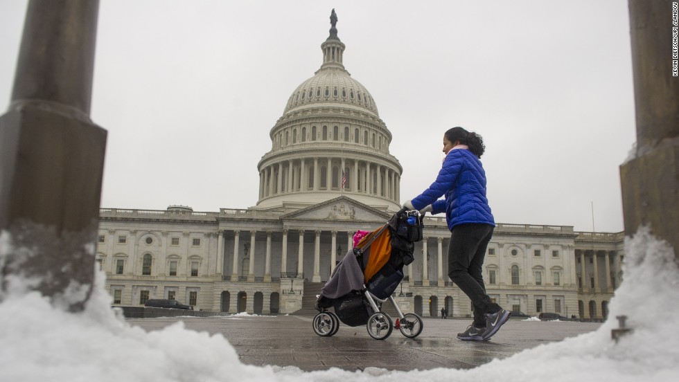 A woman strolls past the Capitol Building in Washington on December 9, after an overnight ice storm hit the region. Federal agencies opened two hours late because of the weather.