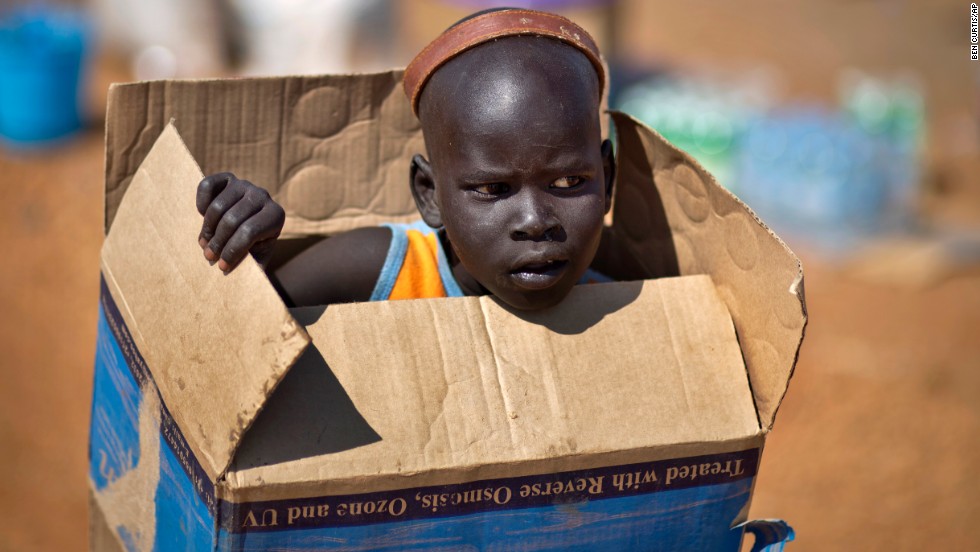 <strong>December 27: </strong>A boy carries a cardboard box in Juba, South Sudan, inside a United Nations compound that has become home to thousands of people displaced by recent fighting in the fledgling African nation.