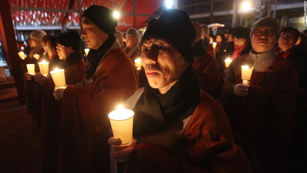 Buddhist monks hold candles during celebrations at a temple in Seoul, South Korea.