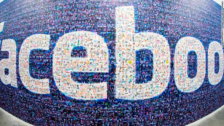 This picture taken with a fisheye lens shows a man walks past a big logo created from pictures of Facebook users worldwide in the company's Data Center, its first outside the US on November 7, 2013 in Luleaa, Swedish Lapland. The company began construction on the facility in October 2011 and went live on June 12, 2013 and are 100% run on hydro power. AFP PHOTO/JONATHAN NACKSTRAND (Photo credit should read JONATHAN NACKSTRAND/AFP/Getty Images)