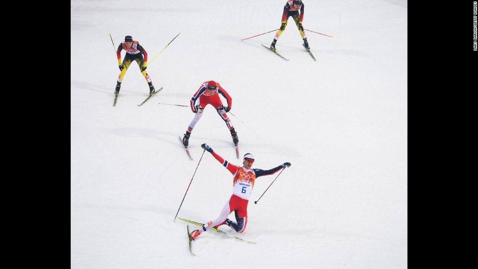 Joergen Graabak of Norway celebrates as he crosses the line to win the gold medal in the large hill Nordic combined event February 18.