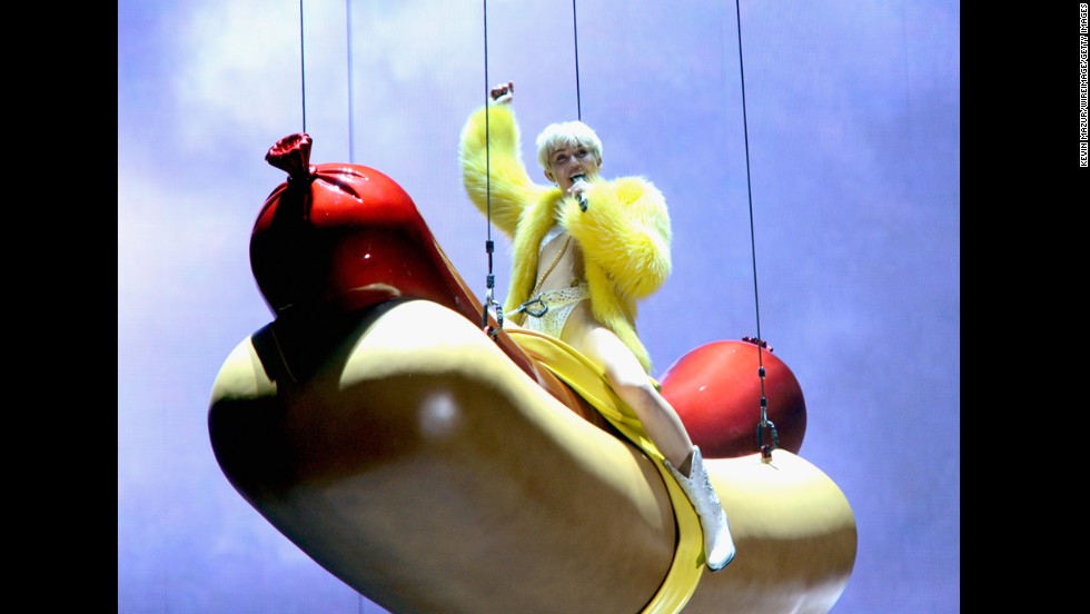 Cyrus rides an oversized hotdog during the Bangerz Tour opening concert in Vancouver, Canada.  