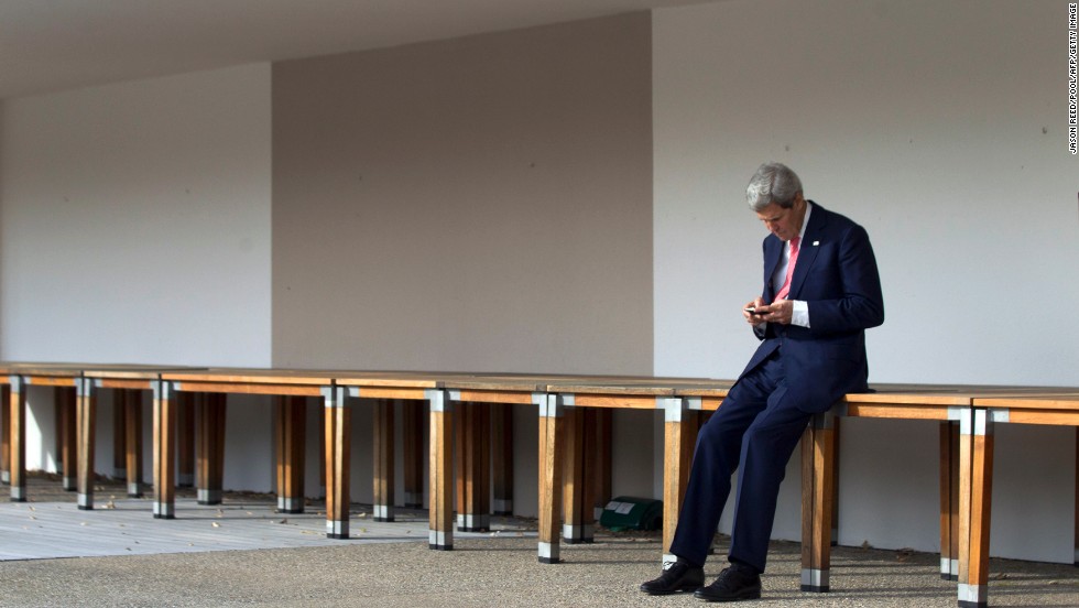 Kerry checks his cell phone in Geneva, Switzerland, prior to a November 2103 meeting with Iran's foreign minister and the European Union's high representative for foreign affairs.