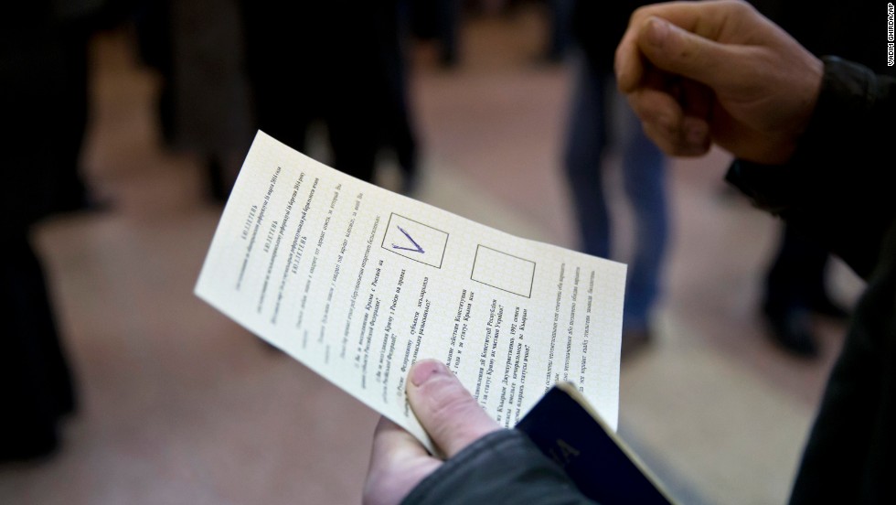 A man holds a ballot after casting a vote in favor of separation from Ukraine in the Crimean referendum in Simferopol, Ukraine, on March 16.