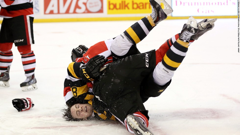 Mack Lemmon of the Kingston Frontenacs falls to the ice after being tackled by Troy Henley of the Ottawa 67's during a fight in their Ontario Hockey League game Tuesday, March 11, in Ottawa.