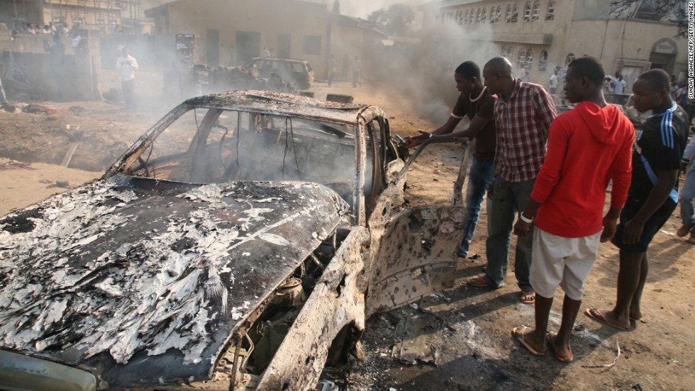 Men look at the wreckage of a car after a bomb blast at St. Theresa Catholic Church outside Abuja on December 25, 2011. A string of bombs struck churches in five Nigerian cities,<a href="http://www.cnn.com/2011/12/25/world/africa/nigeria-church-bombing/index.html"> leaving dozens dead and wounded on the Christmas holiday</a>, authorities and witnesses said. Boko Haram's targets included police outposts and churches as well as places associated with "Western influence."