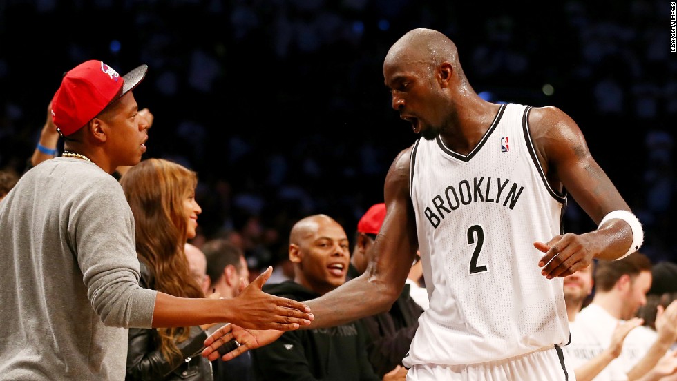 Kevin Garnett of the NBA's Brooklyn Nets is congratulated by rapper Jay-Z during Brooklyn's Game 6 playoff victory against Toronto on Friday, May 2. Brooklyn went on to win Game 7 in Toronto and advance to the Eastern Conference semifinals.