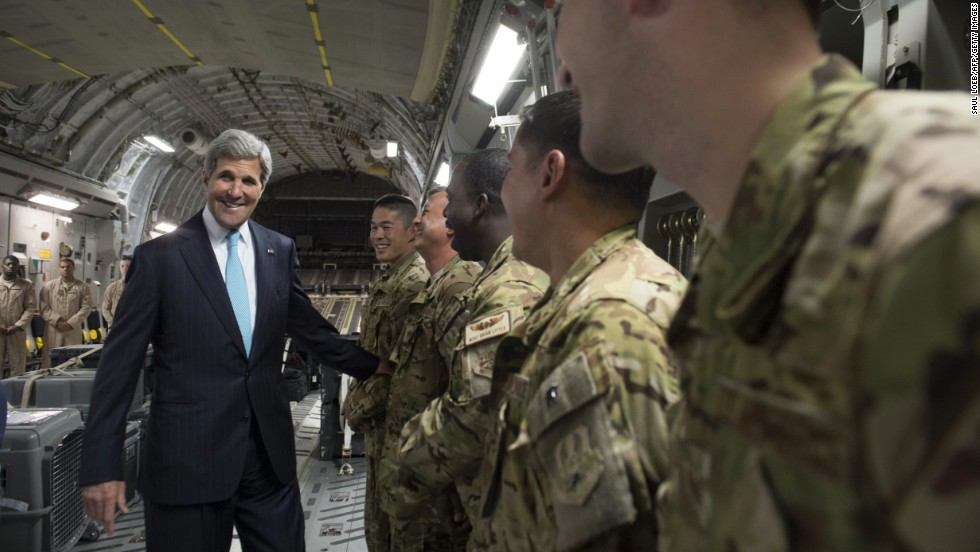 Kerry talks with the crew of a U.S. Air Force plane prior to departure from Addis Ababa, Ethiopia, on Friday, May 2, 2014. He was en route to Juba, South Sudan, to demand a cease-fire in the brutal civil war that has sparked dire warnings of genocide and famine.