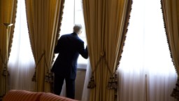 Kerry looks out a window moments before meeting with Algerian President Abdelaziz Bouteflika in Zeralda, Algeria, in April 2014.